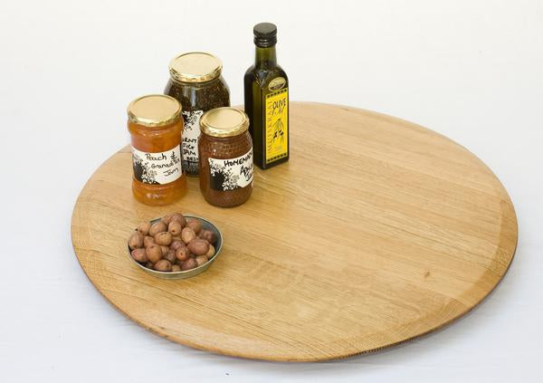 This is a lazy susan with condiments. This wooden turntable is made from recycled oak barrels.