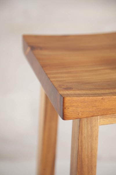 This is a close up of the table top of a bar stool. These bar stools are made from blackwood. The height can be customised to fit into most spaces. 