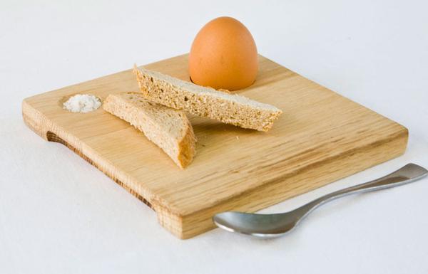 This is a wooden breakfast egg board made from reclaimed wood offcuts. These boards are hand finished. This board has a space for salt, one egg and a some bread. 