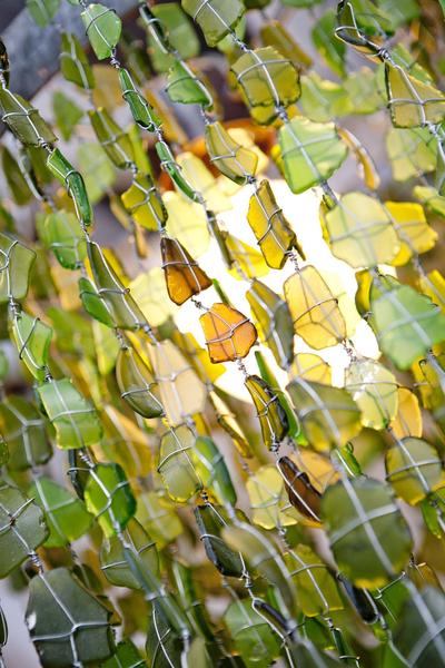 This is a large, recycled glass chandelier containing 3000 green and amber glass beads. Ideal for large living spaces like the dining room, these chandeliers create light and ambience for your home. 