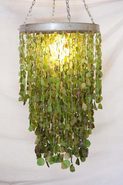 This is a recycled glass chandelier made from and galvanised wine barrel steel made. It has 3 rings and 3000 glass beads. 